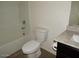 Bathroom with a tub, granite vanity top, toilet and wood look floors at 25744 W Winston Dr, Buckeye, AZ 85326