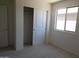 Bedroom featuring carpet, an open closet and window at 25744 W Winston Dr, Buckeye, AZ 85326