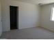 Bedroom features include carpet, a window and closet at 25744 W Winston Dr, Buckeye, AZ 85326