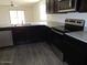 Kitchen features include stainless steel appliances, dark cabinets, granite counters and an island at 25744 W Winston Dr, Buckeye, AZ 85326