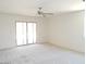 Living Room features a ceiling fan and a sliding glass door to the backyard at 25744 W Winston Dr, Buckeye, AZ 85326