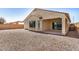 Backyard with a neutral-colored stucco exterior, a covered patio, and a rock groundcover at 25960 W Tonto Ln, Buckeye, AZ 85396