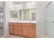 Bathroom with a double sink vanity, a large mirror, tile floors and walk-in shower at 25960 W Tonto Ln, Buckeye, AZ 85396