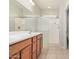 Bathroom features a double sink vanity, shower with sliding glass door, and tile floor at 25960 W Tonto Ln, Buckeye, AZ 85396