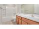 Bathroom featuring a bath/shower combo, wood vanity and neutral finishes at 25960 W Tonto Ln, Buckeye, AZ 85396