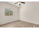 Bedroom with wood floors, ceiling fan and window allowing for natural light at 25960 W Tonto Ln, Buckeye, AZ 85396