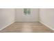 Bedroom with neutral walls, wood floors, large window to let in sunlight at 25960 W Tonto Ln, Buckeye, AZ 85396