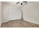 Bright bedroom with wood-look floors and a ceiling fan at 25960 W Tonto Ln, Buckeye, AZ 85396