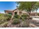 Charming single-story home features a covered entryway and well-maintained front yard with mature landscaping at 25960 W Tonto Ln, Buckeye, AZ 85396