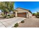 Single-story home featuring a two-car garage and well-maintained front yard with mature landscaping at 25960 W Tonto Ln, Buckeye, AZ 85396
