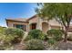 Charming single-story home features a covered entryway and well-maintained front yard with mature landscaping at 25960 W Tonto Ln, Buckeye, AZ 85396