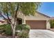 Charming single-story home features a two-car garage and well-maintained front yard with mature landscaping at 25960 W Tonto Ln, Buckeye, AZ 85396