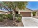 Charming single-story home features a two-car garage and well-maintained front yard with mature landscaping at 25960 W Tonto Ln, Buckeye, AZ 85396