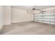 Spacious garage with concrete floors and a white garage door at 25960 W Tonto Ln, Buckeye, AZ 85396