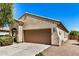 Single-story house featuring a two-car garage with a driveway in a well-kept community at 25960 W Tonto Ln, Buckeye, AZ 85396