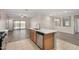 Open kitchen with modern island and view of the backyard through sliding glass doors at 25960 W Tonto Ln, Buckeye, AZ 85396