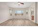Cozy living room features hardwood floors, large windows for ample light and view to bath area at 25960 W Tonto Ln, Buckeye, AZ 85396