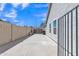 Concrete backyard area, enclosed by a block fence with a metal access gate at 2911 E Leland St, Mesa, AZ 85213