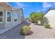 A well-maintained backyard with stone cover and desert landscaping with an access gate at 2911 E Leland St, Mesa, AZ 85213
