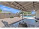 Inviting backyard with a covered patio, gravel landscaping, and a sparkling swimming pool, perfect for outdoor living at 2911 E Leland St, Mesa, AZ 85213