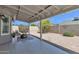 Inviting covered patio with tile flooring, gravel yard and shaded sitting area, creating an ideal outdoor retreat at 2911 E Leland St, Mesa, AZ 85213
