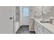 Bright bathroom featuring a shower over tub, white cabinets, and tile at 2911 E Leland St, Mesa, AZ 85213