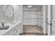 Bright bathroom featuring double sinks, white cabinets, and a walk-in closet at 2911 E Leland St, Mesa, AZ 85213