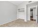 Carpeted bedroom with built in closet with shelving at 2911 E Leland St, Mesa, AZ 85213