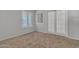 Bedroom with beige carpet, neutral gray walls, and shuttered windows and french doors at 2911 E Leland St, Mesa, AZ 85213