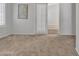 Carpeted bedroom with gray walls and a door leading to another room at 2911 E Leland St, Mesa, AZ 85213