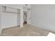 Bedroom with carpet, closet, and an open door to an attached bathroom at 2911 E Leland St, Mesa, AZ 85213