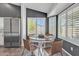 Bright breakfast nook features a round table, wood chairs, and windows with shutter-style blinds at 2911 E Leland St, Mesa, AZ 85213