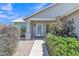 Inviting front entrance with a charming walkway, mature bushes, and ample natural light at 2911 E Leland St, Mesa, AZ 85213