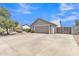 Exterior shot showcasing the two-car garage, a gated entry, and desert landscaping at 2911 E Leland St, Mesa, AZ 85213