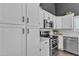 Well-equipped kitchen showcasing stainless steel appliances, ample cabinetry, and stylish backsplash at 2911 E Leland St, Mesa, AZ 85213