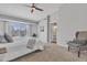Bright main bedroom with a ceiling fan, sliding glass door to the pool, and neutral decor at 2911 E Leland St, Mesa, AZ 85213
