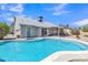 Back exterior showcasing pool, patio, manicured gravel and a covered sitting area great for outdoor entertaining at 2911 E Leland St, Mesa, AZ 85213