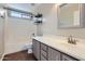 Well-lit bathroom features a shower-tub, dark accents, and a single sink at 29688 W Indianola Ave, Buckeye, AZ 85396