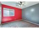 Bright bedroom with ceiling fan, carpet, and large window at 29688 W Indianola Ave, Buckeye, AZ 85396