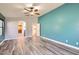 Bright bedroom featuring wood floors, walk-in closet, and ensuite bathroom at 29688 W Indianola Ave, Buckeye, AZ 85396
