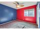 Bright bedroom with ceiling fan, carpet, and big window at 29688 W Indianola Ave, Buckeye, AZ 85396