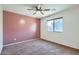 Cozy bedroom with ceiling fan, carpet, and view to backyard at 29688 W Indianola Ave, Buckeye, AZ 85396