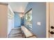 Welcoming entryway with blue walls, built-in storage, a bench, and a view of the front yard at 29688 W Indianola Ave, Buckeye, AZ 85396