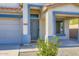 Inviting front entrance with a blue door, decorative trim, and desert-friendly landscaping at 29688 W Indianola Ave, Buckeye, AZ 85396