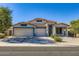 Charming single-story home featuring a three-car garage, tile roof, and well-maintained landscaping at 29688 W Indianola Ave, Buckeye, AZ 85396