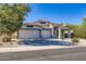 Beautiful home with a three-car garage, desert landscaping, and a classic Southwest architectural style at 29688 W Indianola Ave, Buckeye, AZ 85396