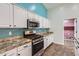 Modern kitchen with stainless steel appliances, granite countertops, and ample cabinet space at 29688 W Indianola Ave, Buckeye, AZ 85396