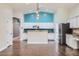 Bright kitchen with white cabinets, stainless appliances, and breakfast bar at 29688 W Indianola Ave, Buckeye, AZ 85396