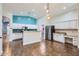 Well-equipped kitchen with white cabinetry, stainless steel appliances, and a breakfast bar at 29688 W Indianola Ave, Buckeye, AZ 85396