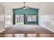 Open living room with vaulted ceilings, neutral carpet, and a sliding glass door to the backyard at 29688 W Indianola Ave, Buckeye, AZ 85396